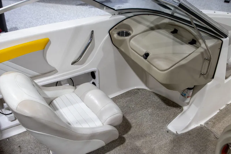Slide: The Image of 2007 Glastron GT 205 Ski & Fish boat interior with white seating and dashboard. - 6
