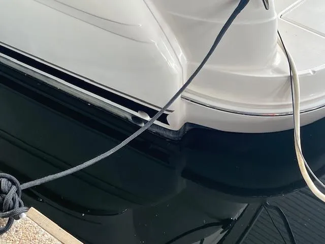 Slide: The Image of 2004 Sea Ray 390 Motor Yacht docked, showing sleek white hull and mooring lines. - 12