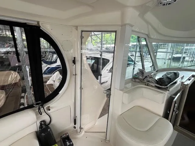 Slide: The Image of Interior view of 2004 Sea Ray 390 Motor Yacht, featuring seating and windows. - 14