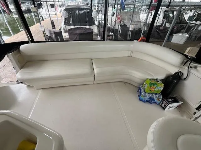 Slide: The Image of 2004 Sea Ray 390 Motor Yacht interior with white seating and marina view. - 15