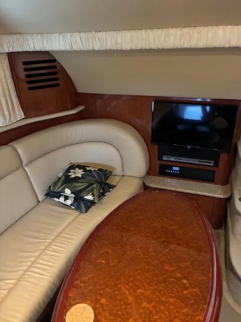 Slide: The Image of 2004 Sea Ray 390 Motor Yacht interior with leather seating, TV, and wooden table. - 20