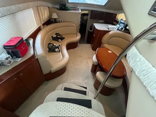 Slide: The Image of 2004 Sea Ray 390 Motor Yacht interior with plush seating and elegant wood finishes. - 21