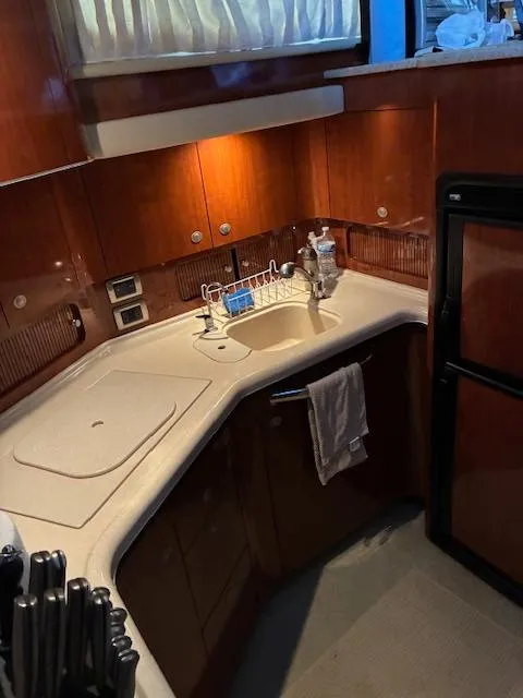 Slide: The Image of 2004 Sea Ray 390 Motor Yacht kitchen with wood cabinetry and modern appliances. - 27