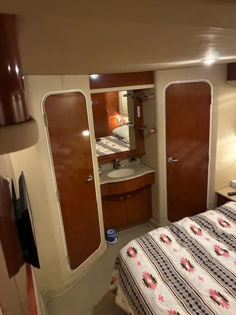 Slide: The Image of Interior of 2004 Sea Ray 390 Motor Yacht with cozy bedroom and wooden cabinetry. - 29