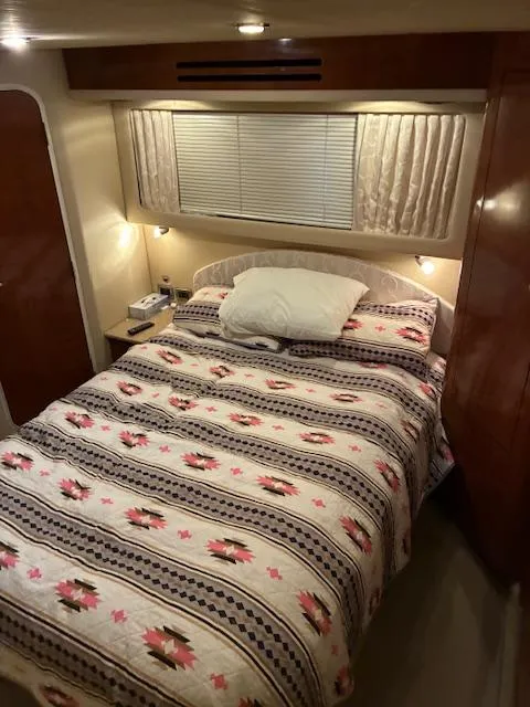 Slide: The Image of Cozy bedroom in 2004 Sea Ray 390 Motor Yacht with patterned bedding and warm lighting. - 30