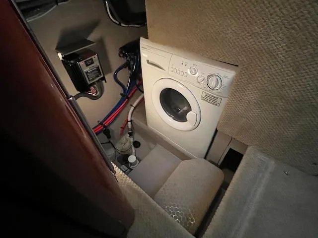 Slide: The Image of Laundry area inside 2004 Sea Ray 390 Motor Yacht with washing machine and electrical components. - 32