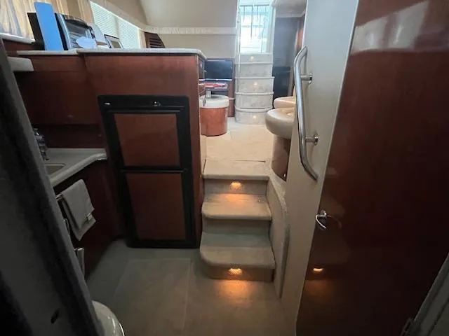 Slide: The Image of Interior of 2004 Sea Ray 390 Motor Yacht with stairs, kitchenette, and modern design. - 35