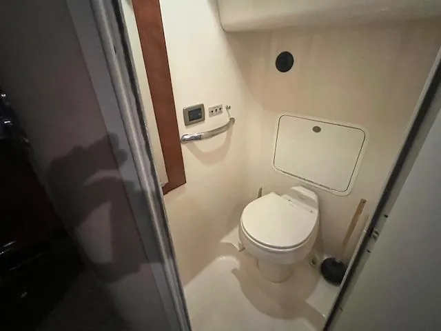Slide: The Image of 2004 Sea Ray 390 Motor Yacht bathroom with toilet and control panel. - 38