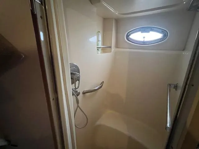 Slide: The Image of Shower area in 2004 Sea Ray 390 Motor Yacht with oval window and chrome fixtures. - 39