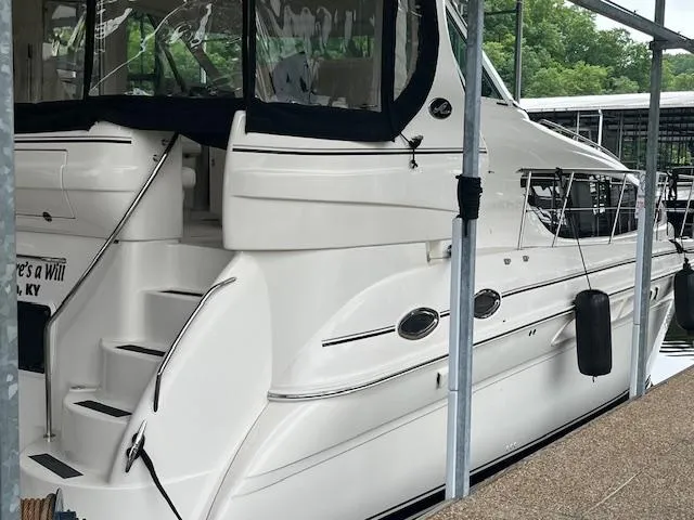 Slide: The Image of 2004 Sea Ray 390 Motor Yacht docked, featuring sleek white design and spacious deck. - 4