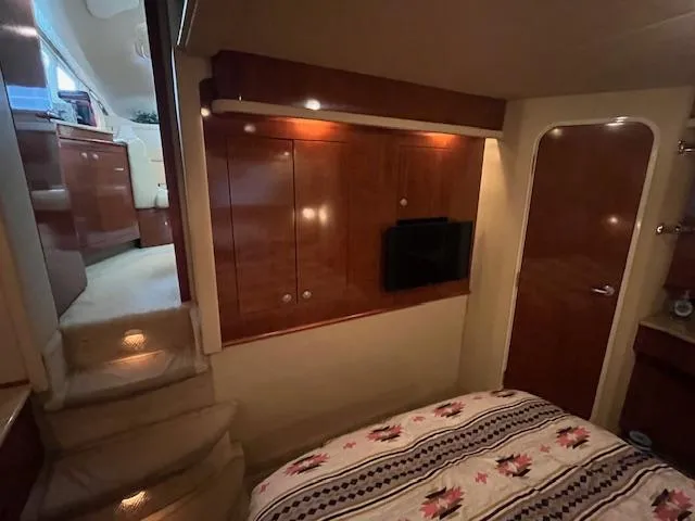 Slide: The Image of Interior of 2004 Sea Ray 390 Motor Yacht with cozy bedroom and wooden cabinetry. - 41