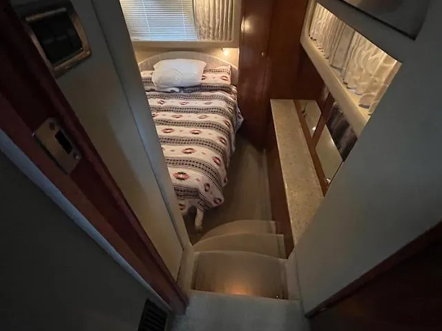 Slide: The Image of 2004 Sea Ray 390 Motor Yacht interior cabin with bed and stairs. - 43