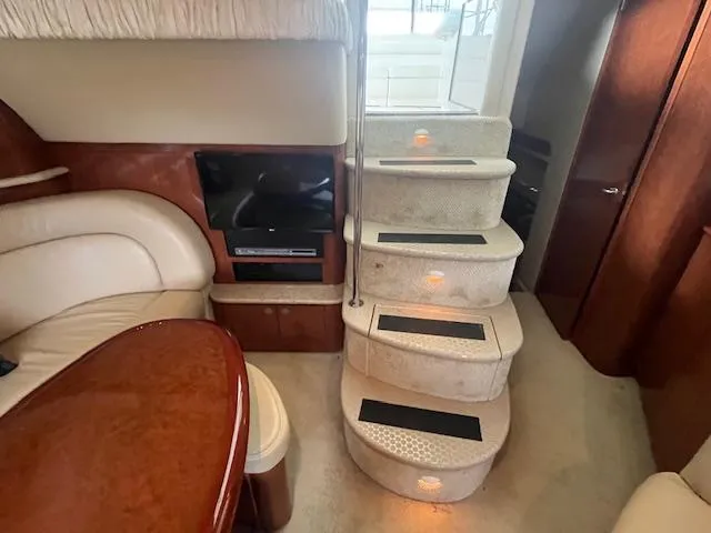 Slide: The Image of Interior of 2004 Sea Ray 390 Motor Yacht with stairs and seating area. - 44