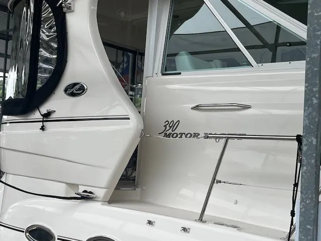 Slide: The Image of 2004 Sea Ray 390 Motor Yacht, white exterior, docked in marina. - 5