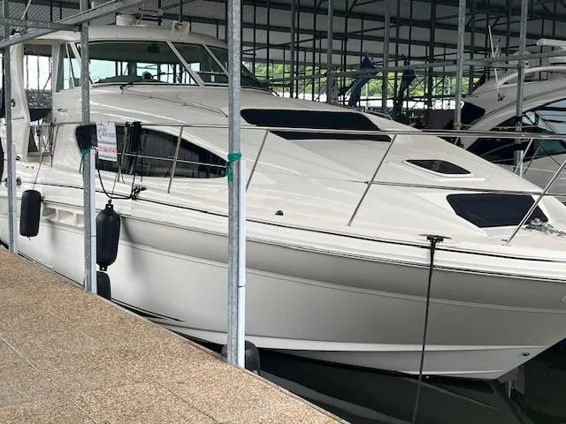 Slide: The Image of 2004 Sea Ray 390 Motor Yacht docked in a marina, side view. - 7