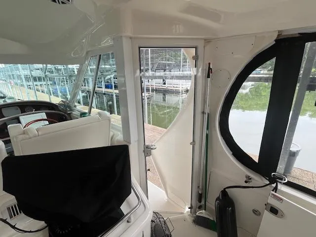 Slide: The Image of Interior view of a 2004 Sea Ray 390 Motor Yacht, showcasing helm and seating area. - 8