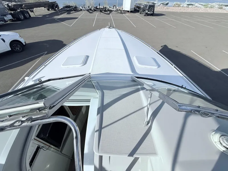 Slide: The Image of 2000 Formula 330 Sun Sport boat, top view, open hatch, parked in a lot. - 12