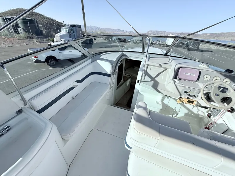 Slide: The Image of 2000 Formula 330 Sun Sport boat interior with steering wheel and seating area. - 13