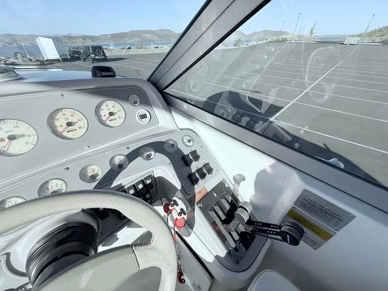 Slide: The Image of Cockpit view of a 2000 Formula 330 Sun Sport boat with dashboard controls and gauges. - 14
