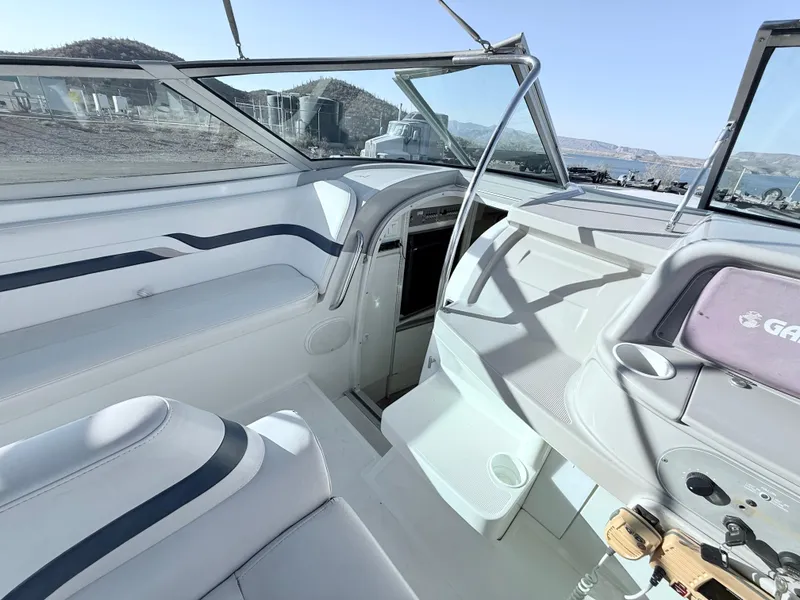 Slide: The Image of 2000 Formula 330 Sun Sport boat interior with white seating and dashboard. - 15