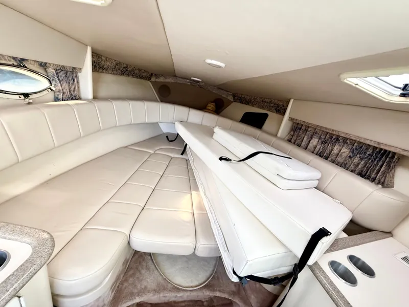 Slide: The Image of Interior of 2000 Formula 330 Sun Sport boat with beige seating and compact design. - 16