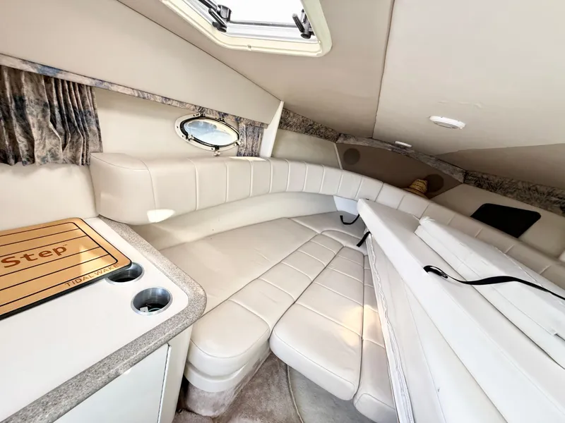 Slide: The Image of Interior of 2000 Formula 330 Sun Sport boat with white leather seating and compact kitchenette. - 17