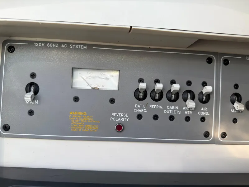 Slide: The Image of Control panel of a 2000 Formula 330 Sun Sport boat, featuring various switches and a voltmeter. - 21