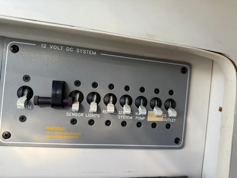 Slide: The Image of Control panel of a 2000 Formula 330 Sun Sport boat's 12-volt DC system. - 22