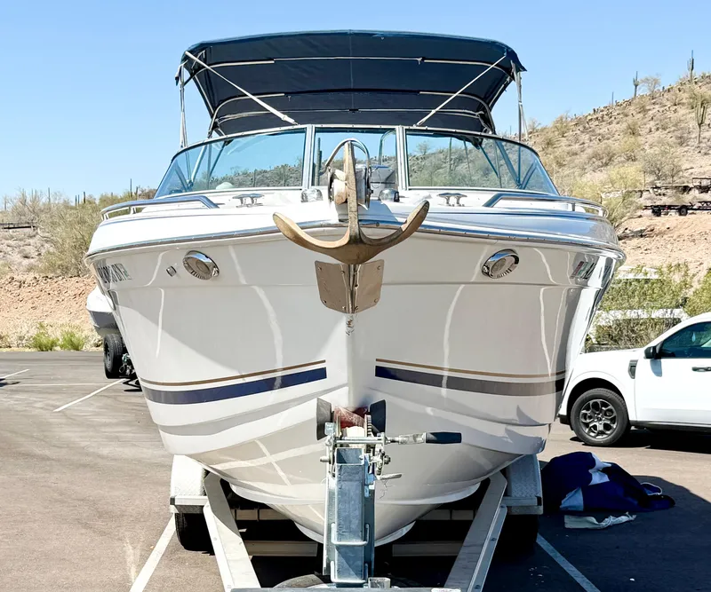 Slide: The Image of 2000 Formula 330 Sun Sport boat on trailer, parked outdoors under clear sky. - 3