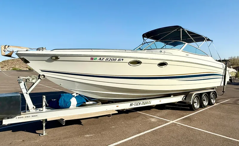 Slide: The Image of 2000 Formula 330 Sun Sport boat on trailer in parking lot. - 5