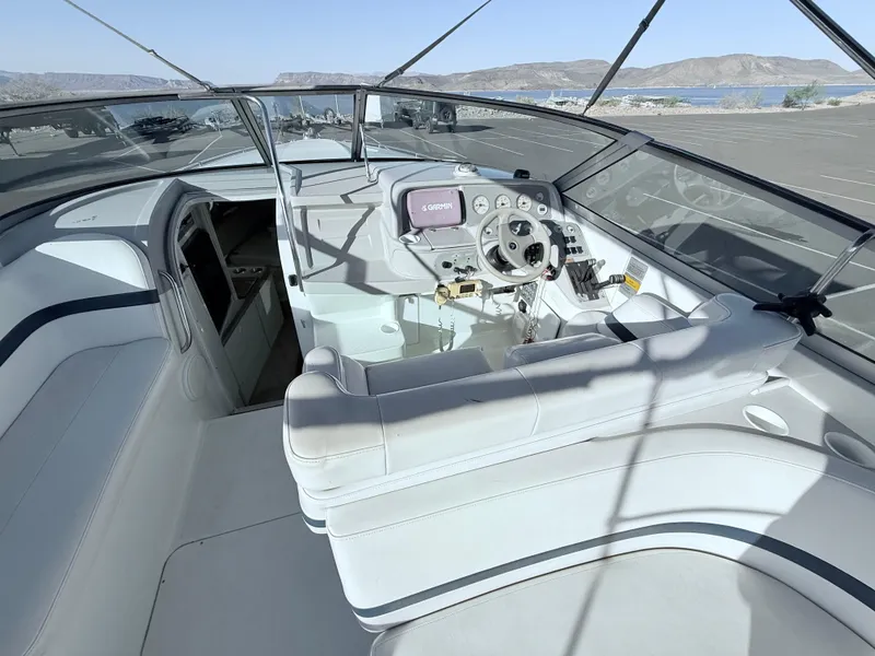 Slide: The Image of 2000 Formula 330 Sun Sport boat interior with steering wheel and seating. - 9
