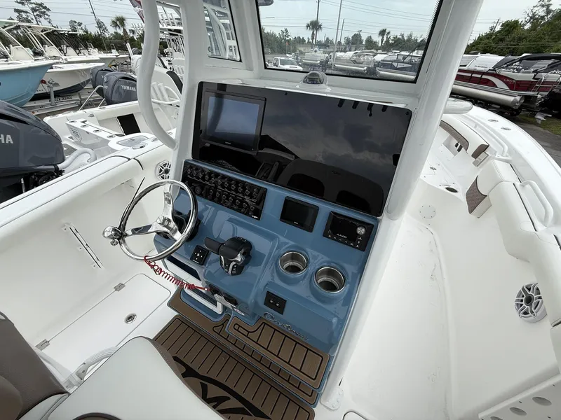 Slide: The Image of 2025 Tidewater 272 LXF boat helm with Seakeeper, featuring modern controls and steering wheel. - 12