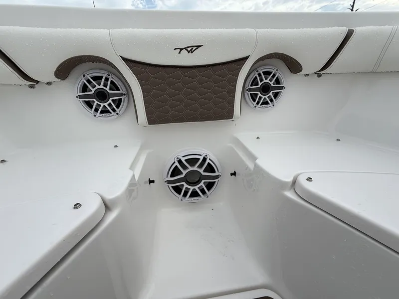 Slide: The Image of Interior of 2025 Tidewater 272 LXF boat with speakers and cushioned seating. - 6