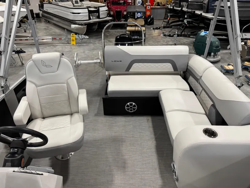 Slide: The Image of 2022 Lowe 210 SS pontoon boat interior with plush seating and modern design. - 10