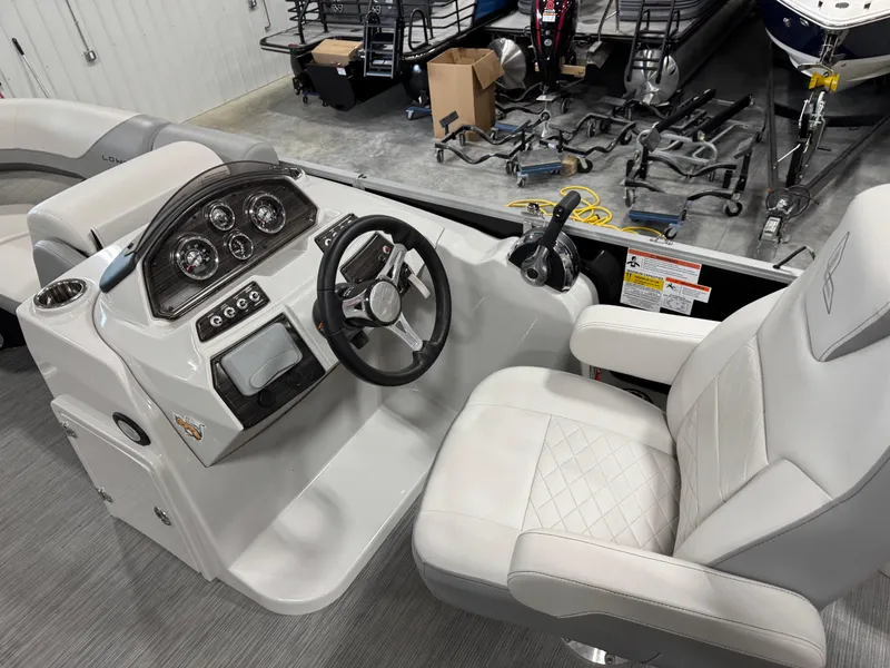 Slide: The Image of 2022 Lowe 210 SS boat interior with steering console and captain's chair in showroom. - 12
