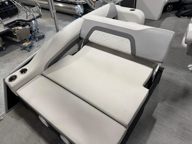 Slide: The Image of 2022 Lowe 210 SS boat seating with cup holders, featuring white and gray upholstery. - 13