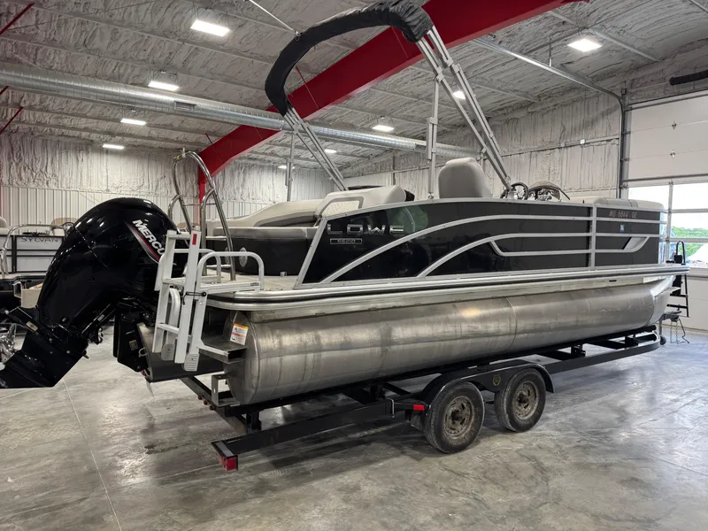 Slide: The Image of 2022 Lowe 210 SS pontoon boat on trailer in indoor storage facility. - 3