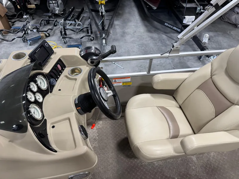 Slide: The Image of Captain's seat and dashboard of a 2015 Lowe 210 SS boat, featuring gauges and controls. - 10