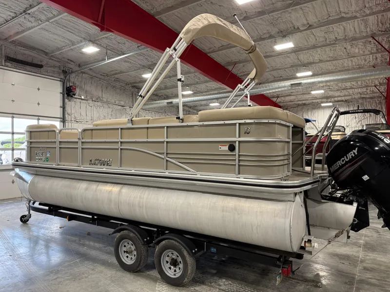 Slide: The Image of 2015 Lowe 210 SS pontoon boat on trailer in indoor storage facility. - 4