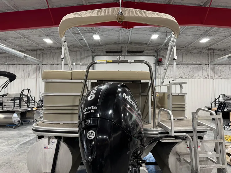 Slide: The Image of 2015 Lowe 210 SS pontoon boat with Mercury outboard motor in indoor storage. - 5