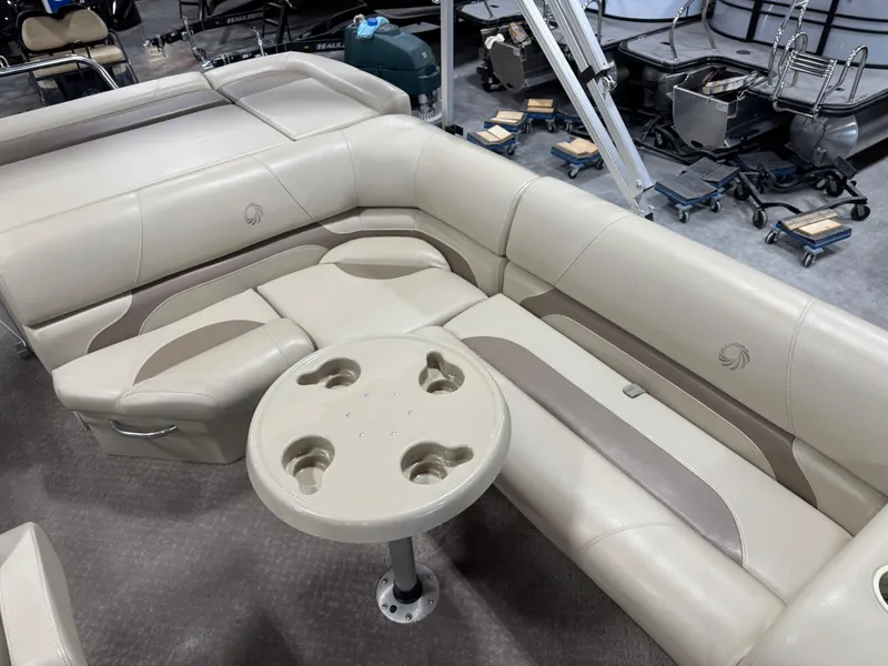 Slide: The Image of 2015 Lowe 210 SS boat interior with beige seating and cup holder table. - 8