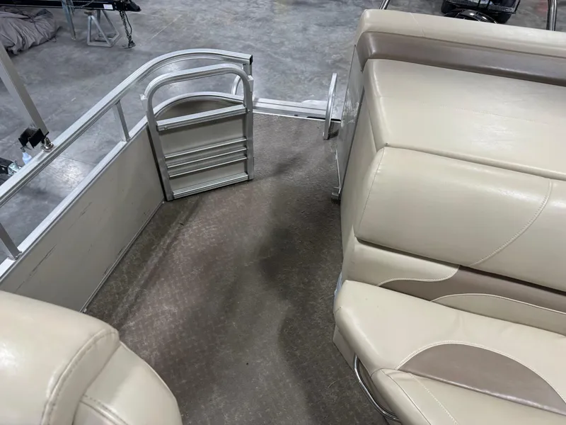 Slide: The Image of Interior of a 2015 Lowe 210 SS boat with beige seating and metal ladder. - 9