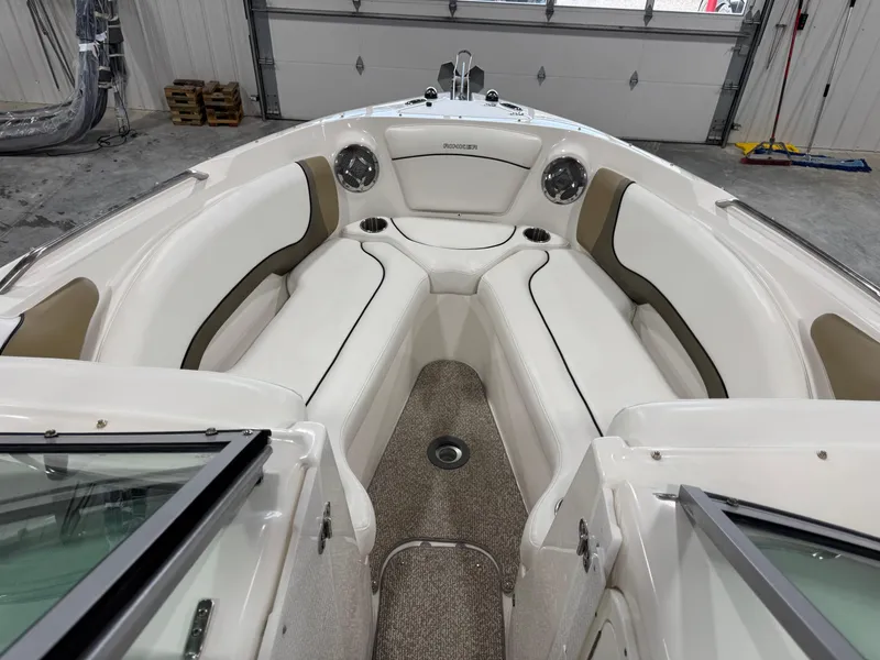 Slide: The Image of 2012 Rinker 296 Captiva Bowrider interior with white seating and cup holders. - 10