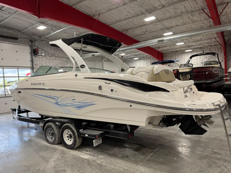 Slide: The Image of 2012 Rinker 296 Captiva Bowrider on trailer in indoor storage facility. - 3