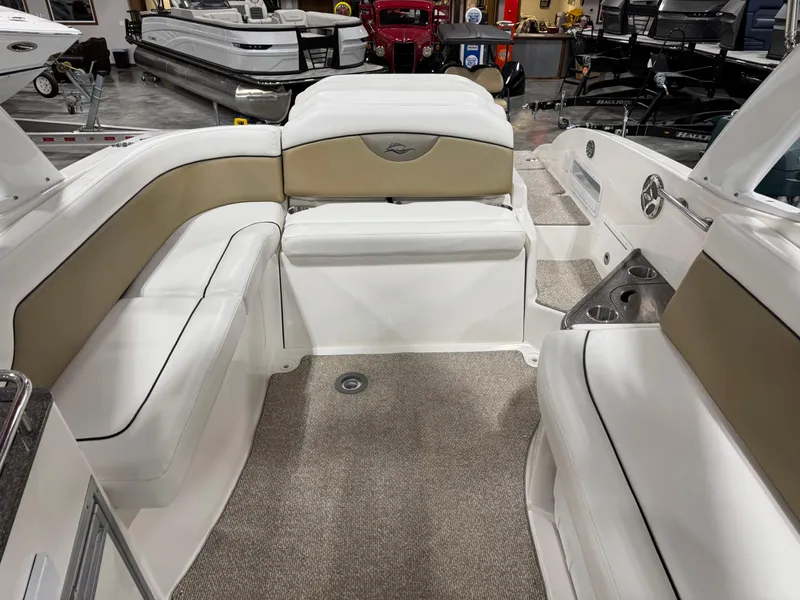Slide: The Image of 2012 Rinker 296 Captiva Bowrider interior with beige and white seating. - 7
