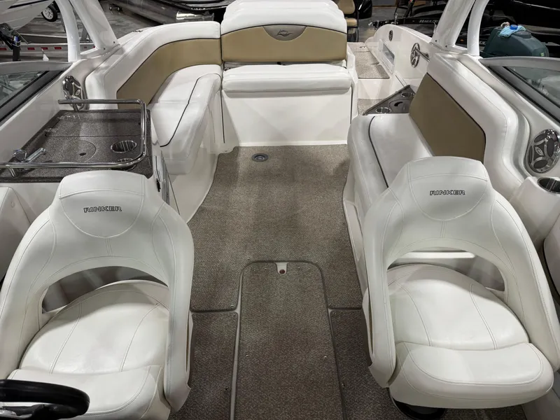 Slide: The Image of 2012 Rinker 296 Captiva Bowrider interior with white seating and carpeted flooring. - 8