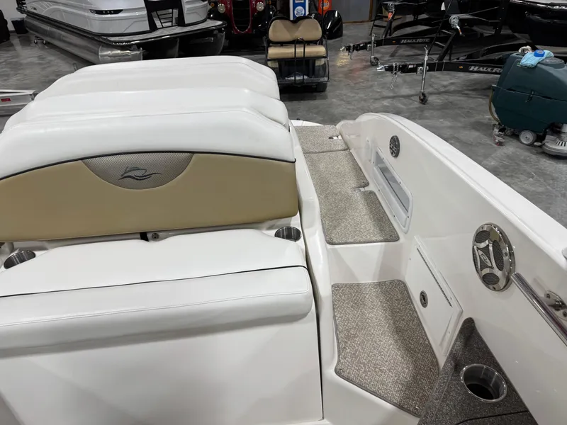 Slide: The Image of 2012 Rinker 296 Captiva Bowrider interior with white seating and beige accents. - 9