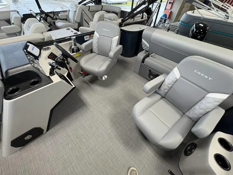 Slide: The Image of 2025 Crest Classic 220 SLSC Tritoon interior with modern seating and control panel. - 4