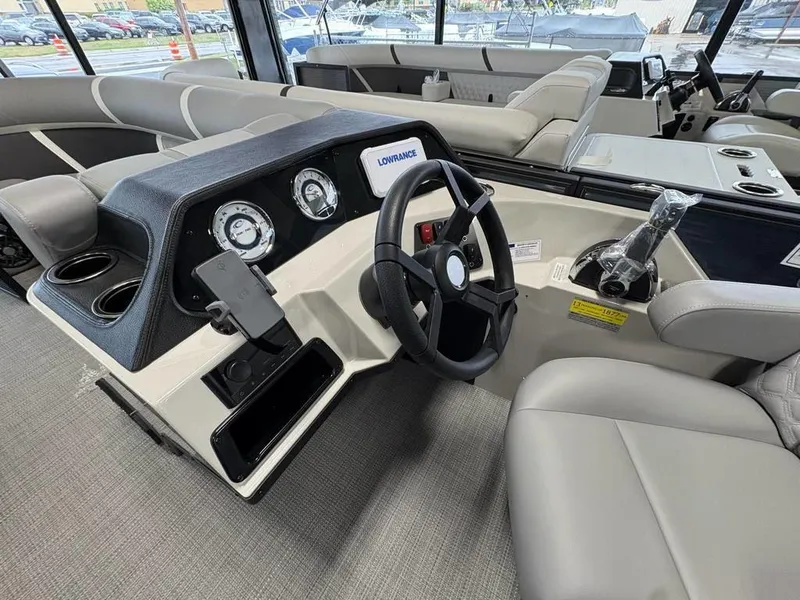 Slide: The Image of 2025 Crest Classic 220 SLSC Tritoon interior with steering wheel and dashboard controls. - 5