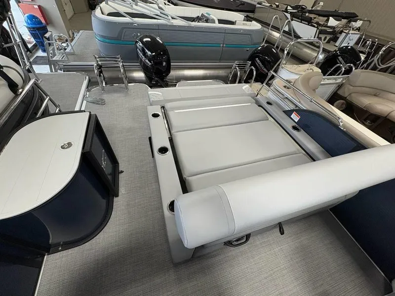 Slide: The Image of 2025 Crest Classic 220 SLSC Tritoon interior with seating and storage features. - 6
